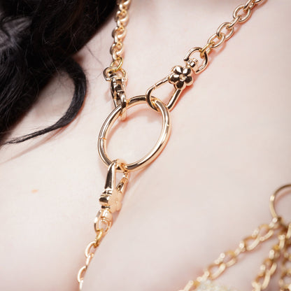 Close-up of a gold chain bdsm collar necklace on a person's neck